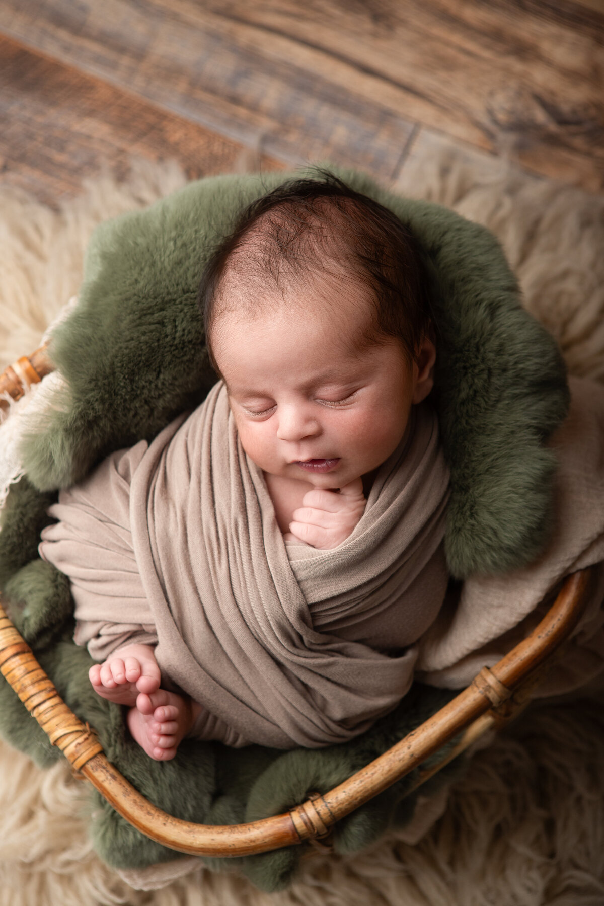 baby in a bucket with luneberry rabbit fur