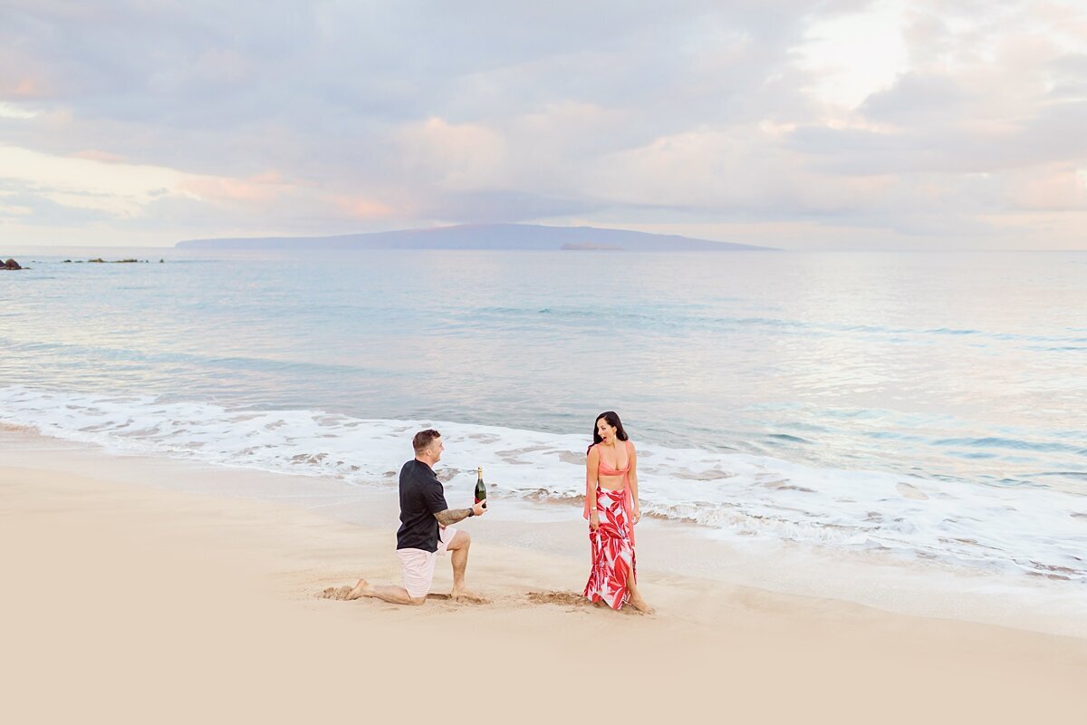 Man gets down on one knee to propose to the love of his life on a Maui beach