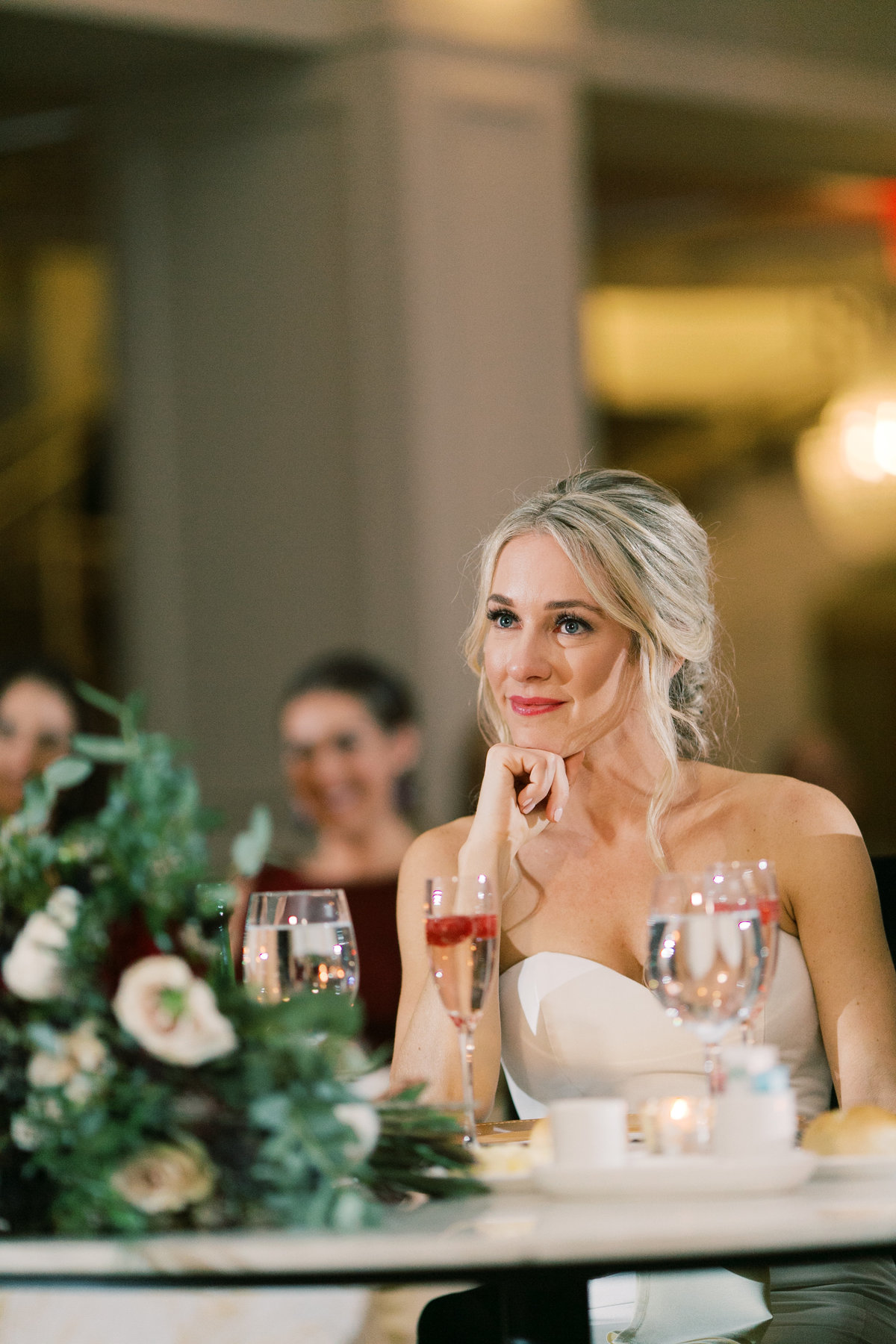 bride listening to speeches during wedding reception in Philadelphia