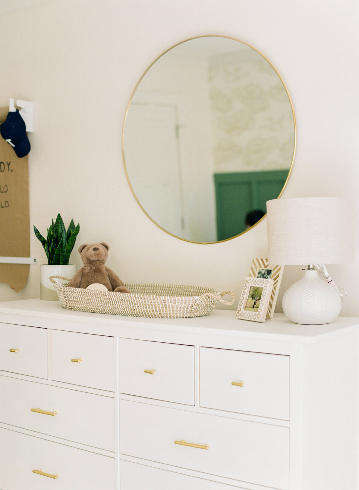 Neutral changing table with round gold mirror during Raleigh NC newborn session. Photo by Raleigh Newborn Photography A.J. Dunlap Photography.