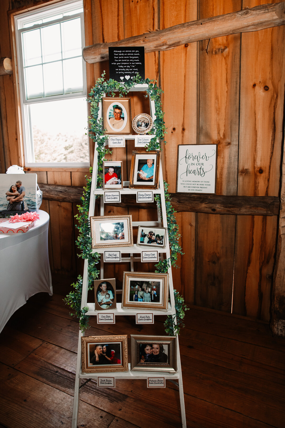 A ladder at a wedding reception used to hold photos as a memorial of those who couldn't make it