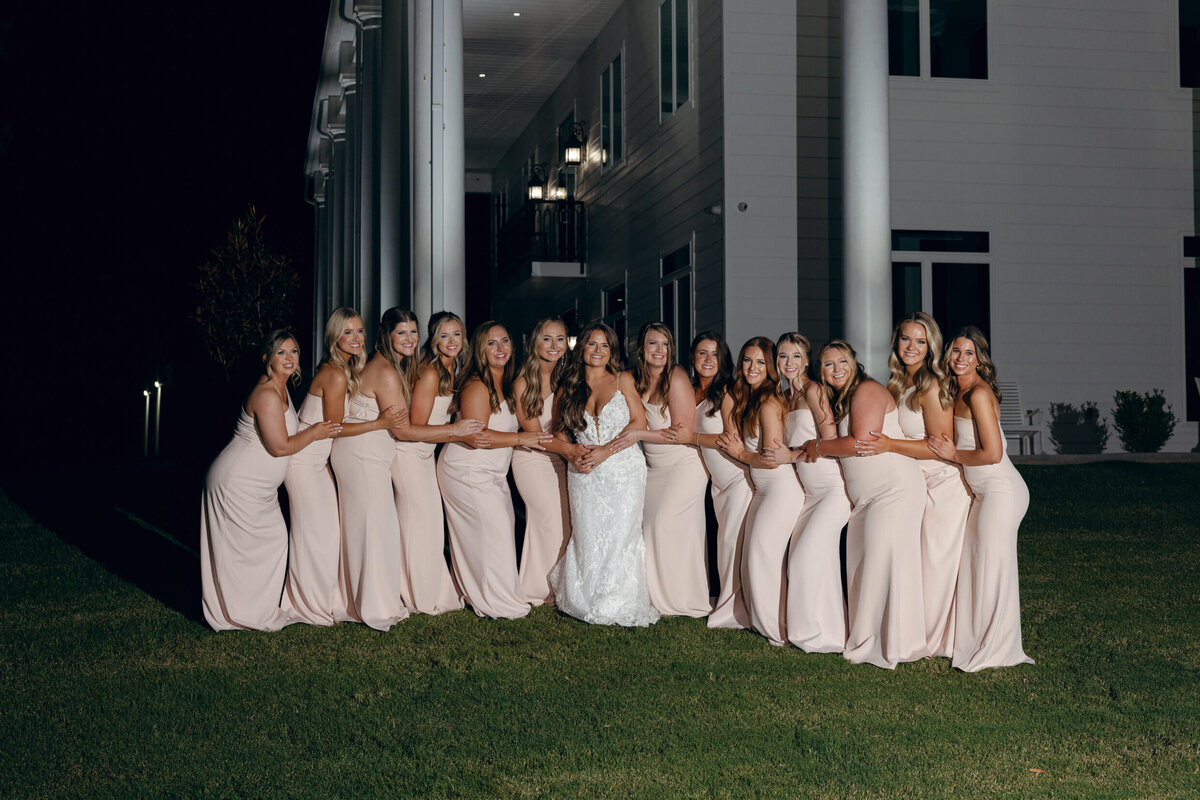 A photo of the bride and her bridesmaids in front of the wedding venue  Legacy Acres