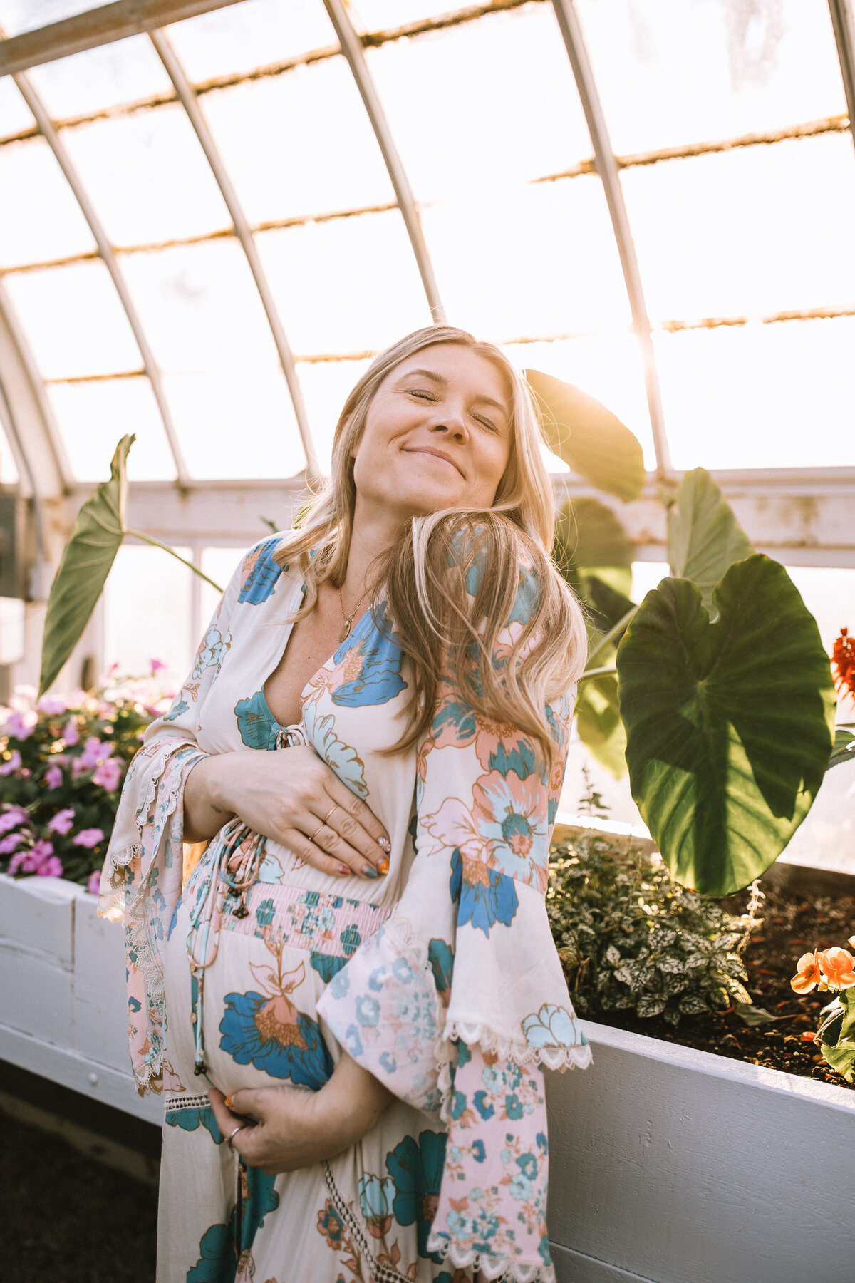 Pregnant woman in a greenhouse at The Frick. 
