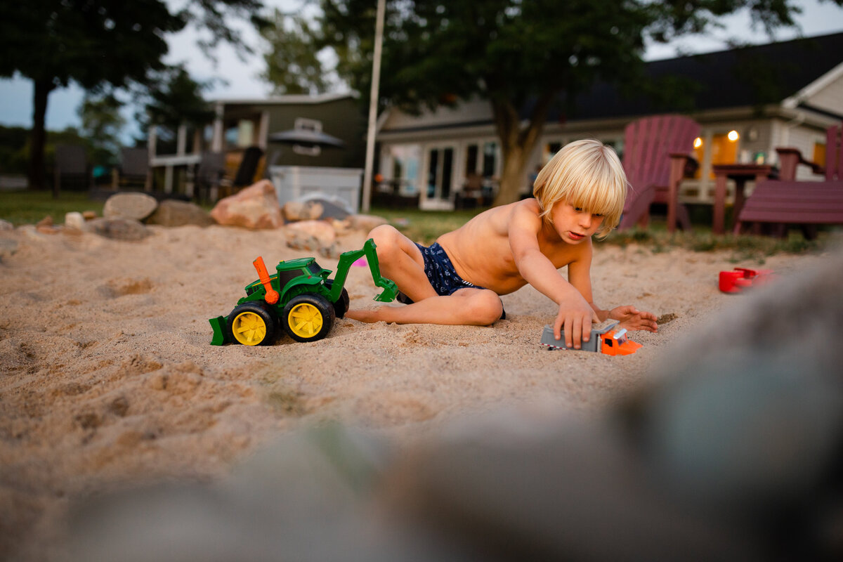 child-playing-beach-sand