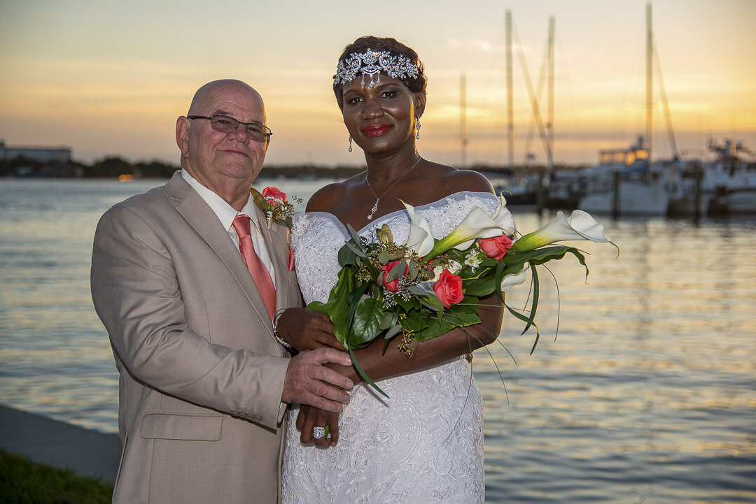 Newlyweds pose at sunset for their wedding portraits.