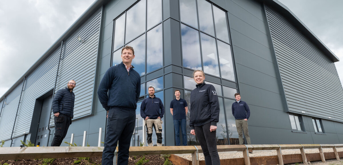 The EMC team standing outside of their large warehouse