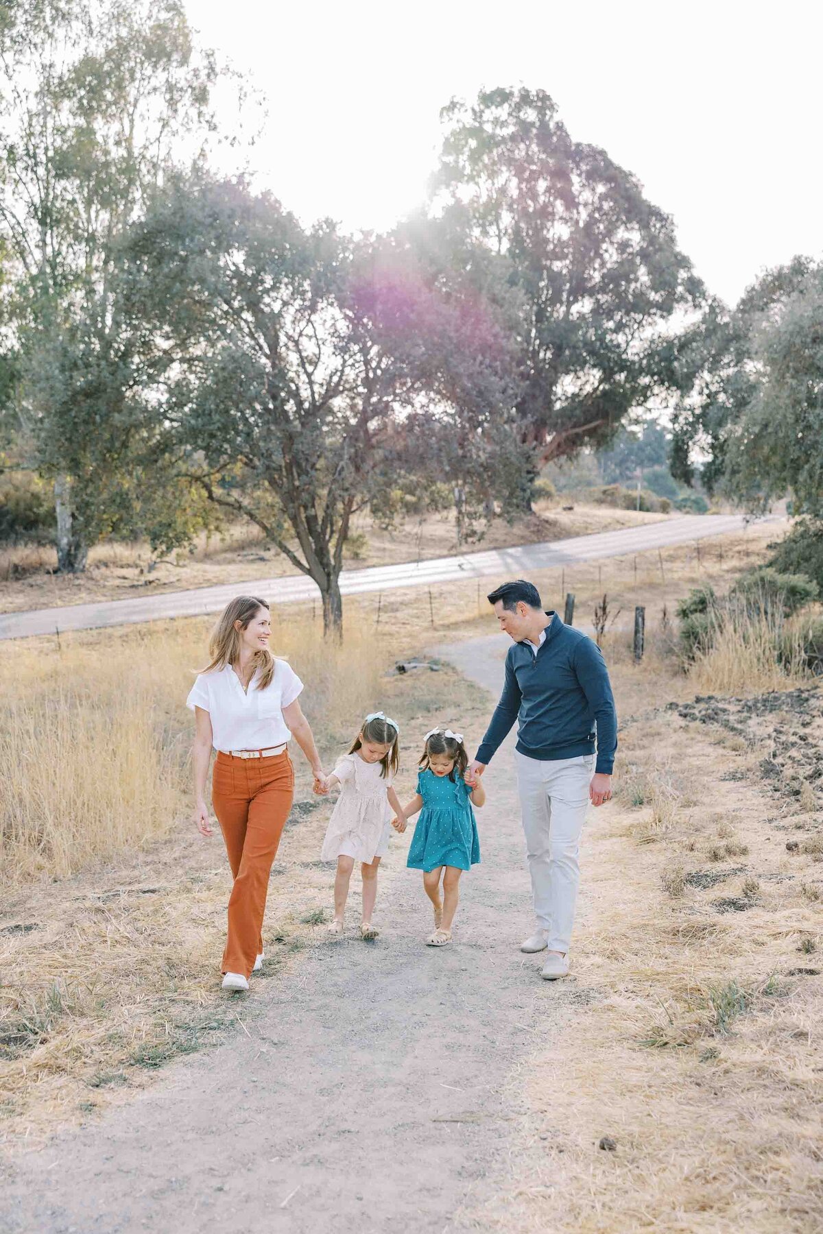 family of 4 walking during sunset