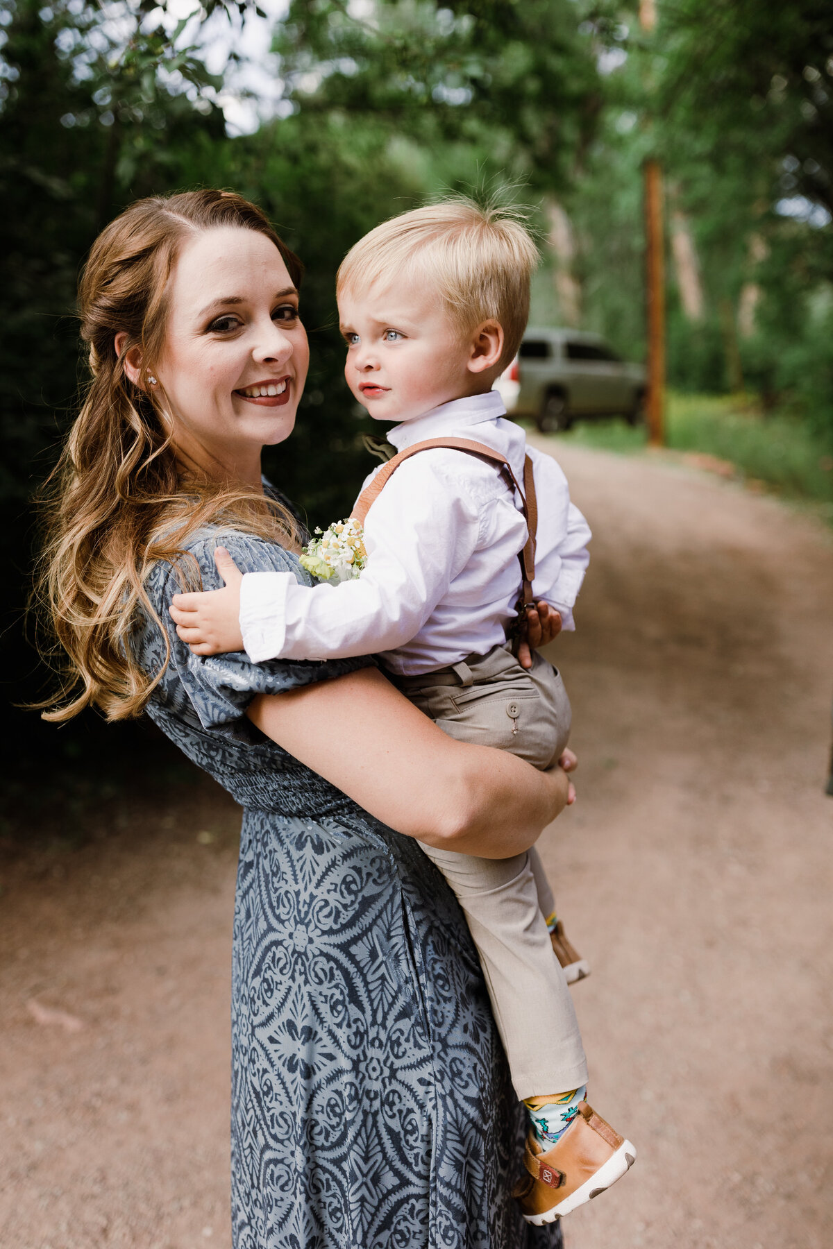 Woman holding young boy ready for wedding at Dallenbach Ranch Colorado