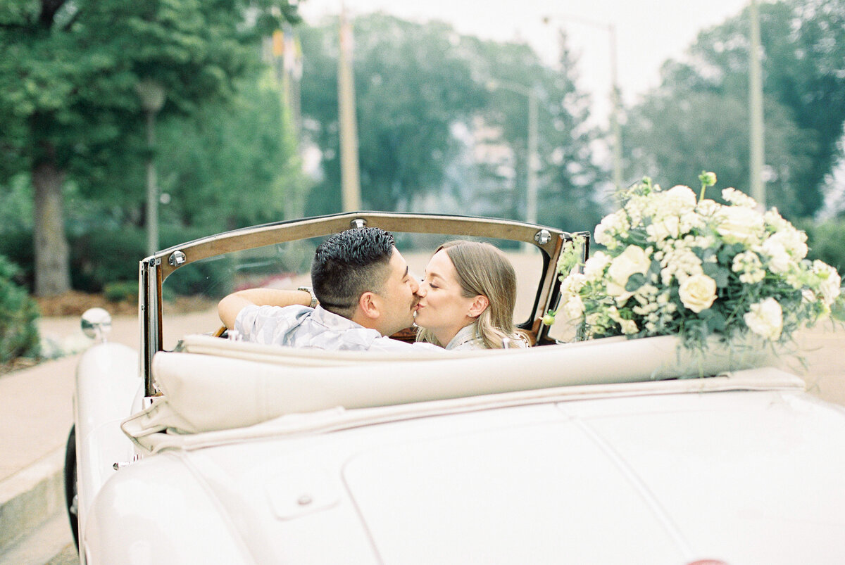 couple kissing in vintage jaguar