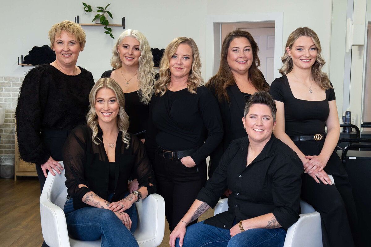 A team photo of the staff of Richardson Hair Design.  Everyone is wearing black outfits.  Captured by Ottawa branding photographer JEMMAN Photography