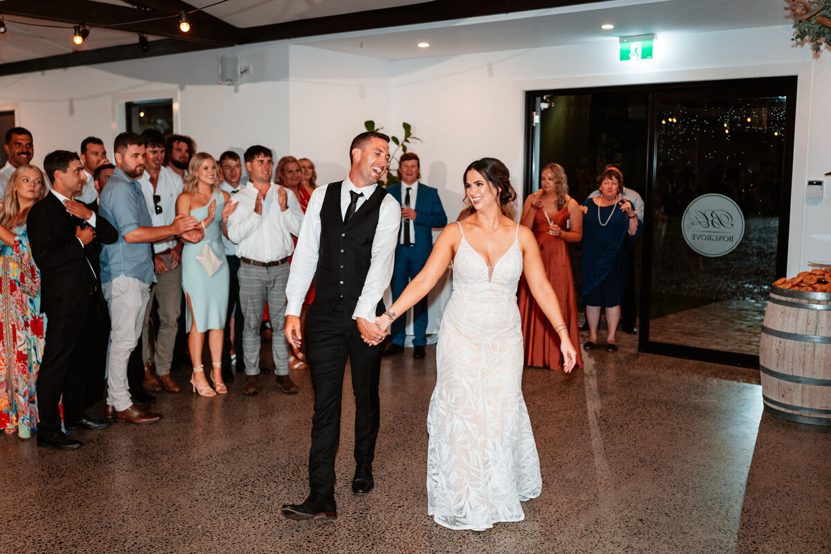 Mikaeley & Lachlan having fun getting into their wedding reception