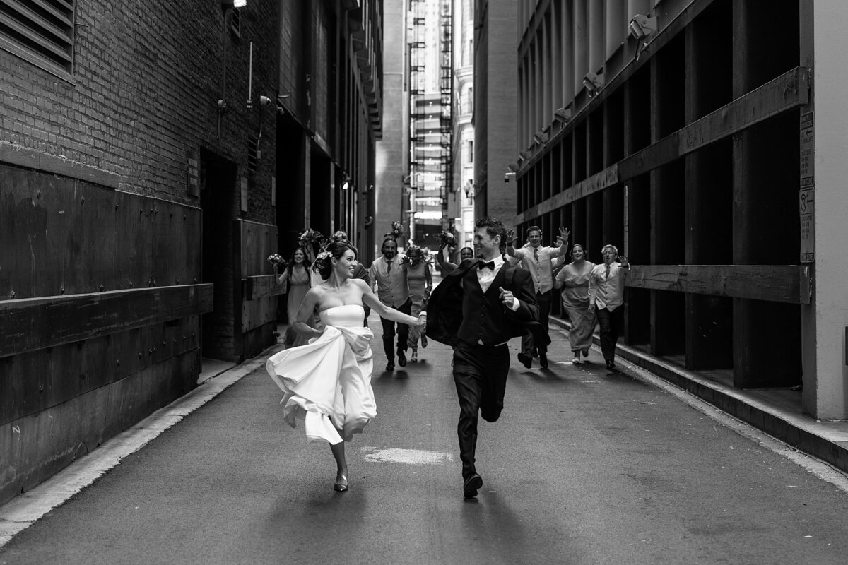 Bride and groom are being chased by crazy bridal party in the dark alley of Chicago