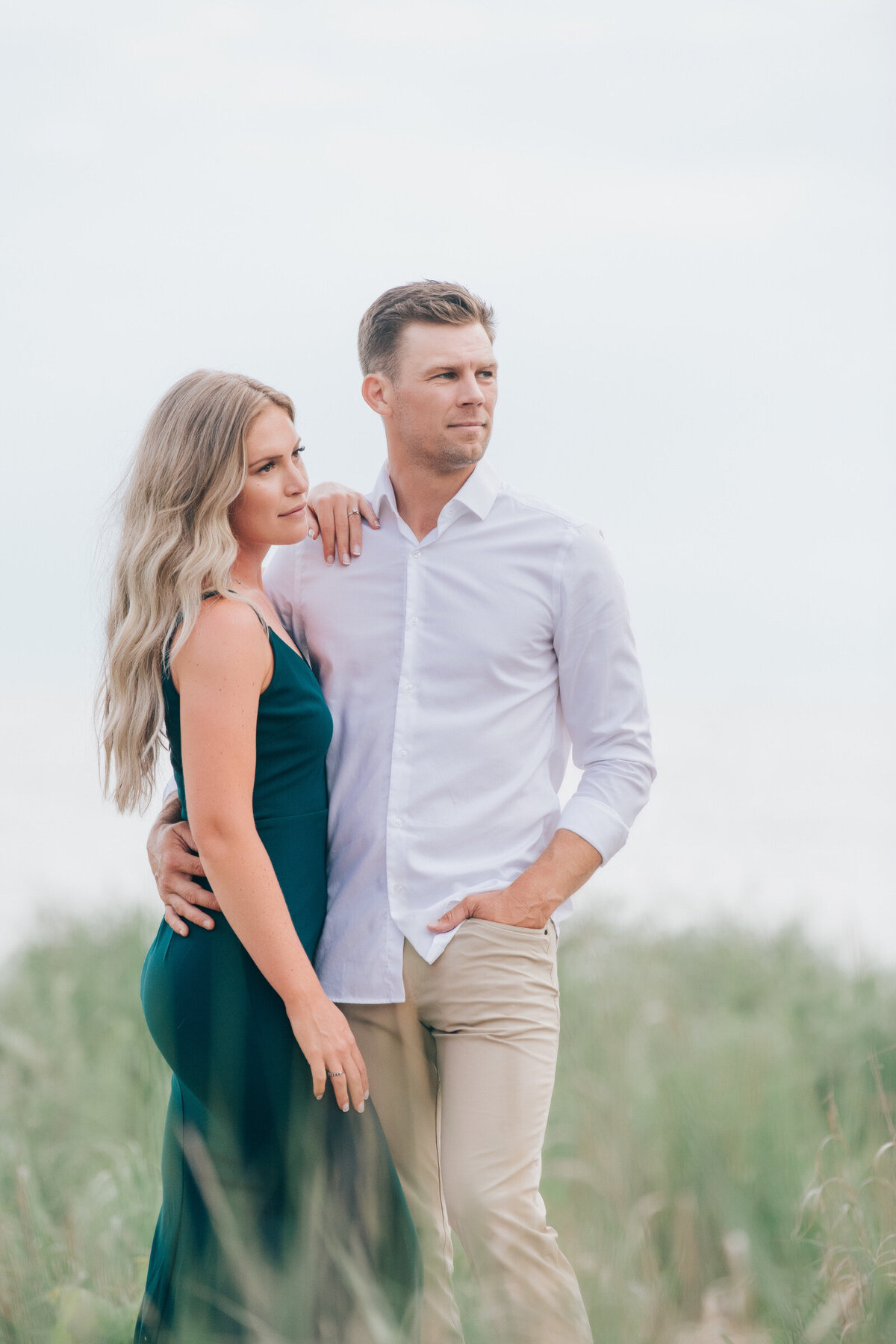 Couple posing on the beach for their summer engagement session
