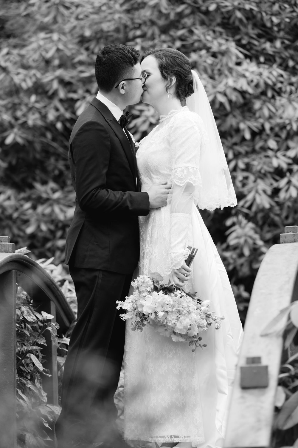 bride and groom kiss at kubota garden black and white portrait