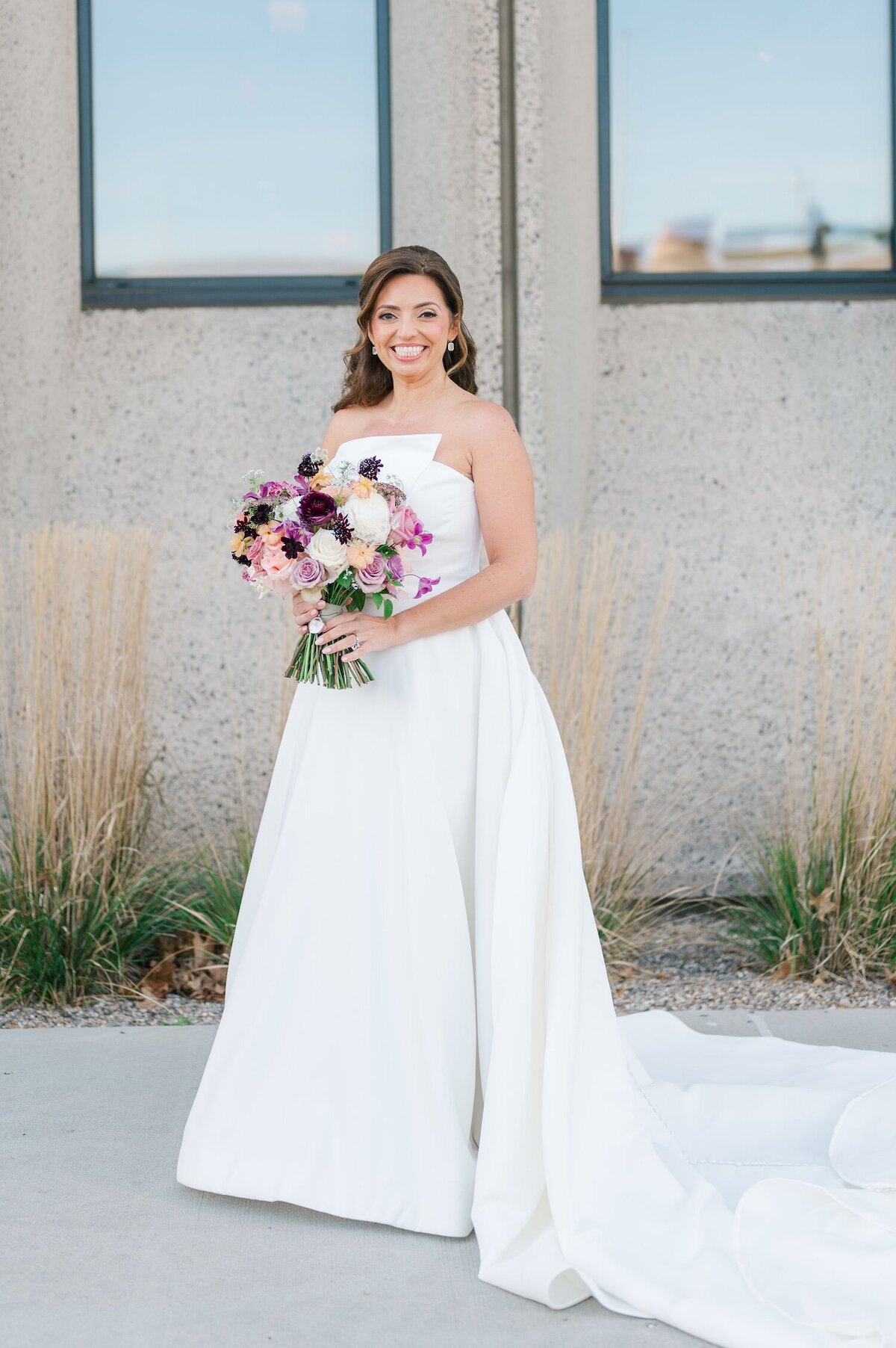 A bridal potrait of a bride wearing a strapless dress outside of Hotel Marcel. 