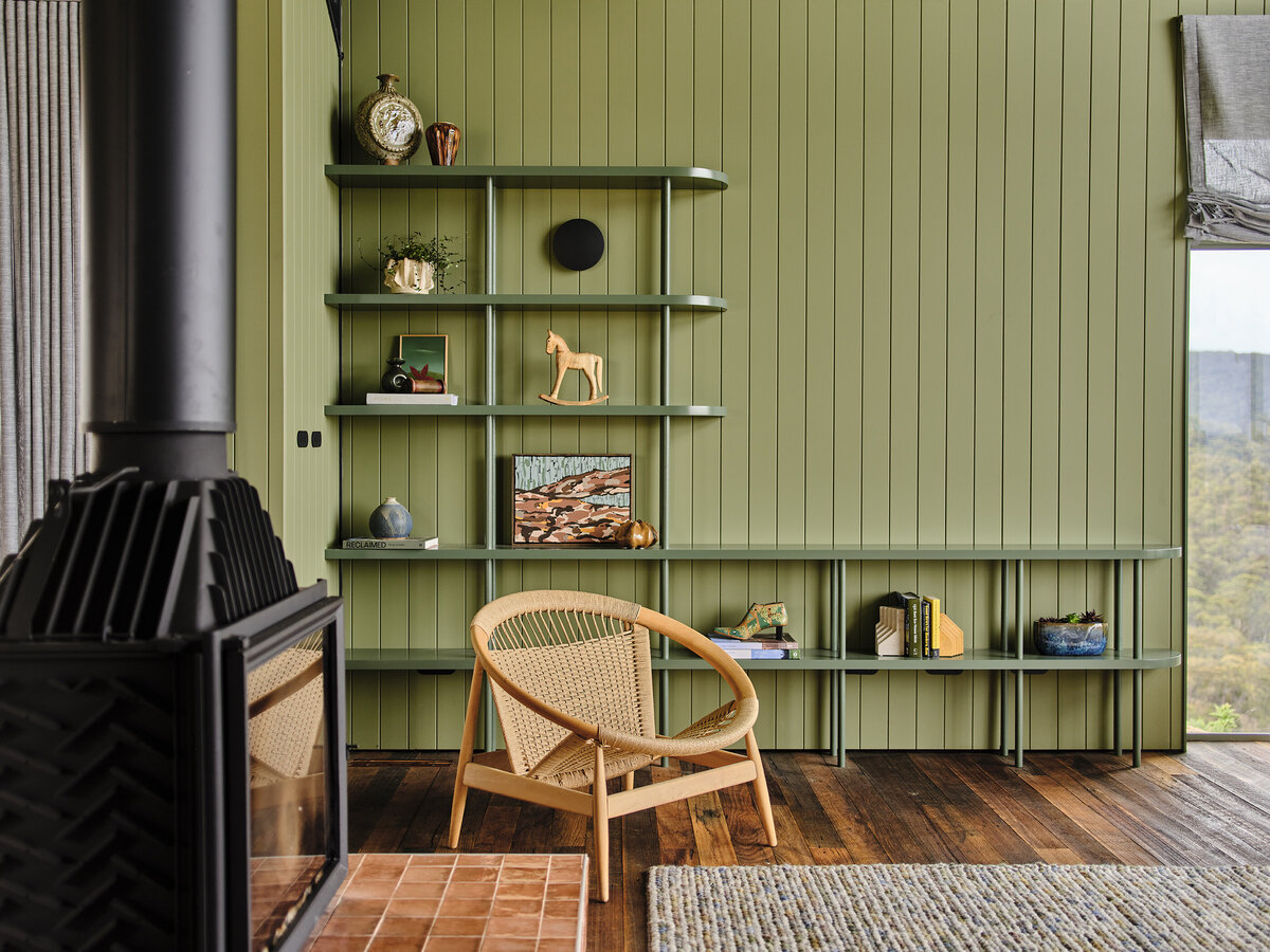 Living space with modern fireplace, sculptural timber shelving and relaxed reading corner by interior stylist Lisa Hunter Interiors.