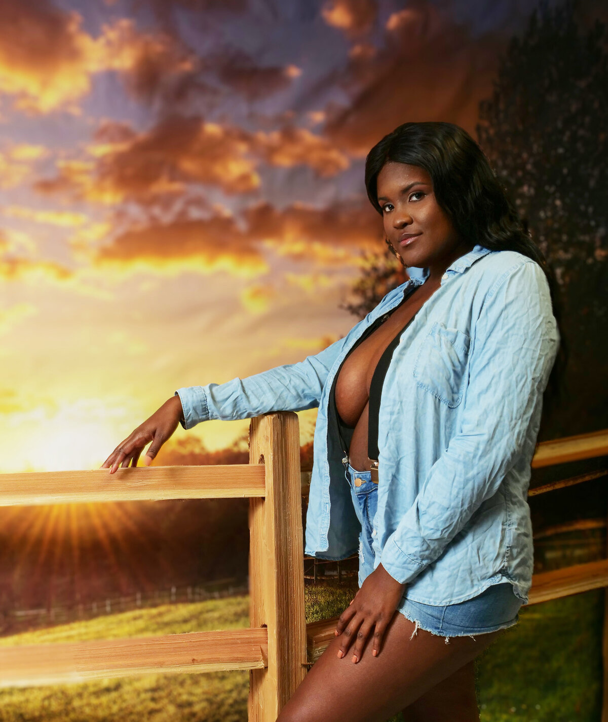 Black cowgirl with open shirt looking into the sunset