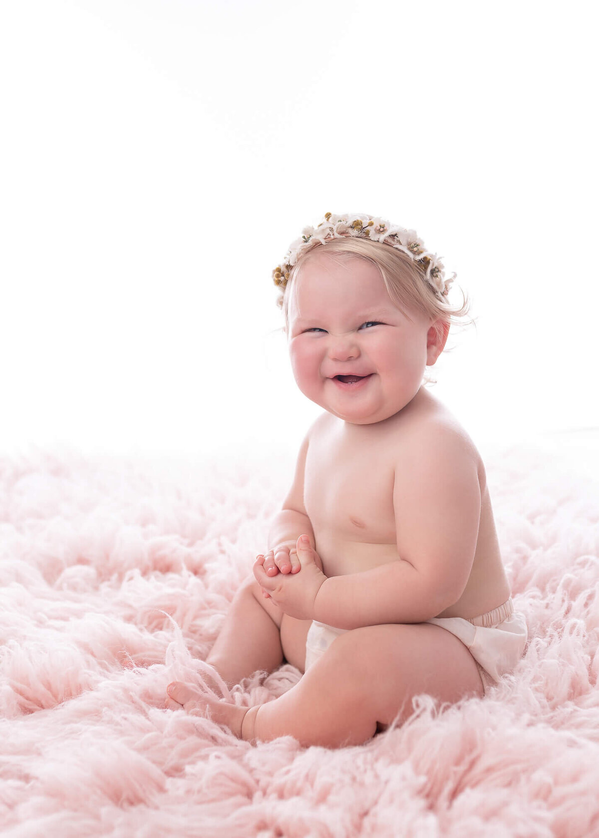 baby girl on pink rug