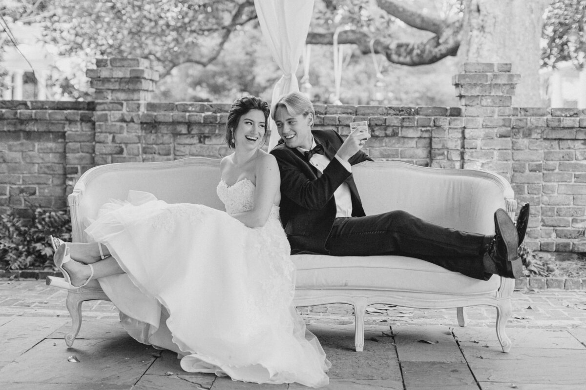 Bride and groom on the couch during cocktail hour at William Aiken House.