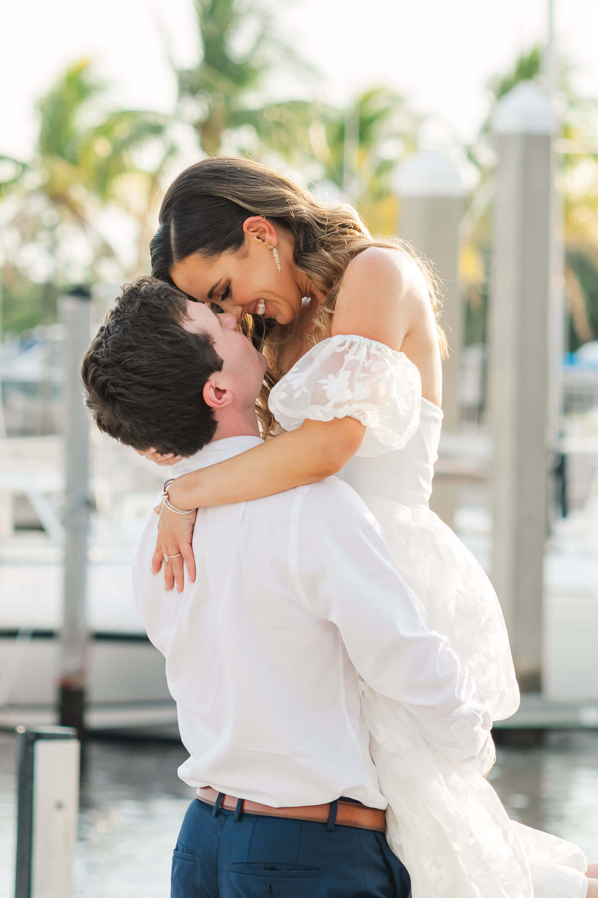 a couple about to kiss  on a marina