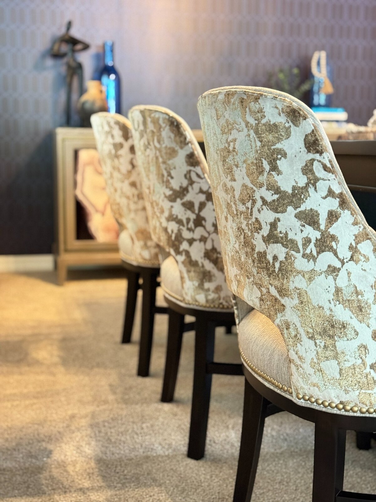 Row of custom velvet dining chairs with gold accents and nailhead trim in a sophisticated Scottsdale dining room.