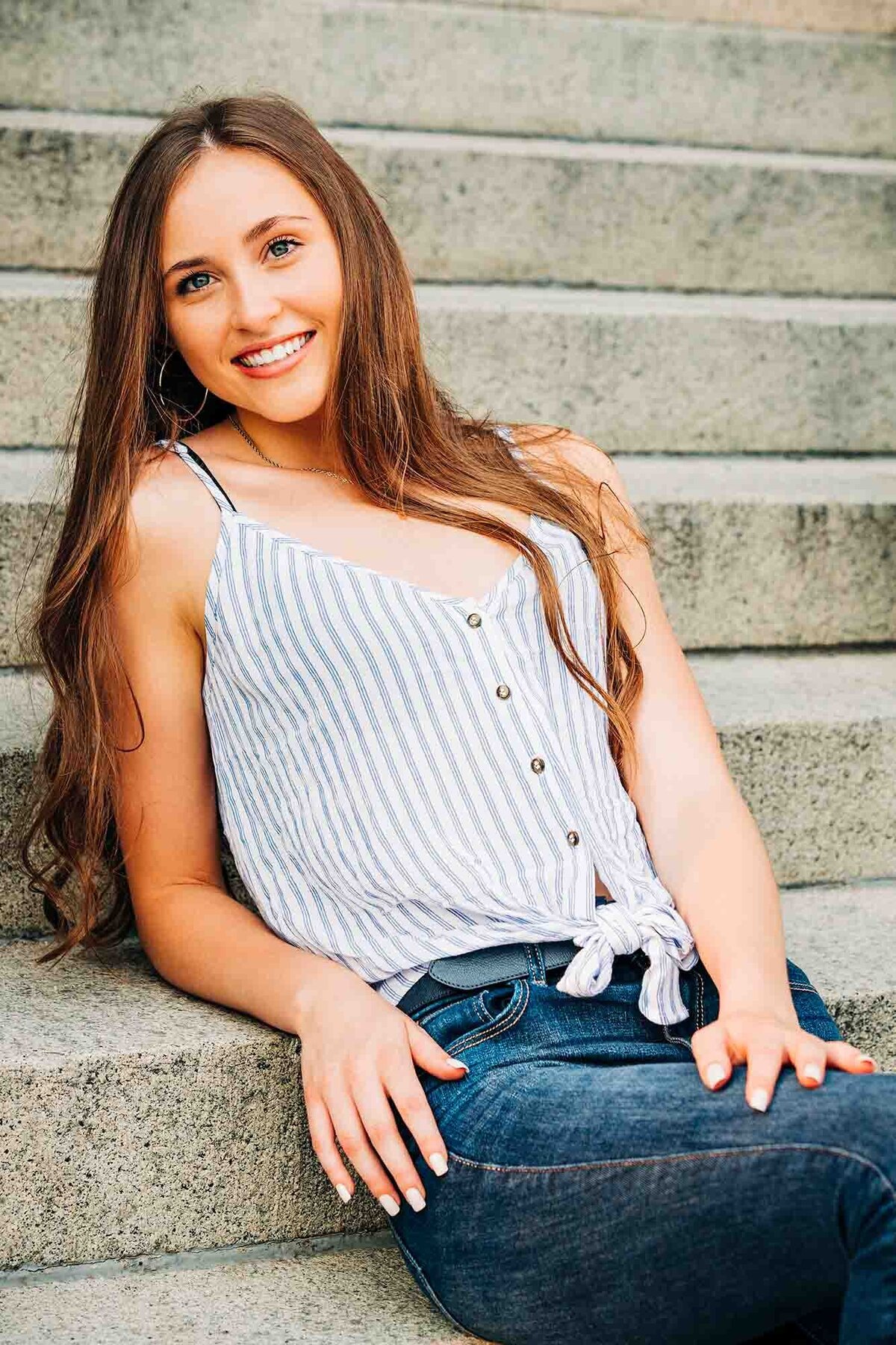 Senior photo Missoula girl sitting on steps on University of Montana campus