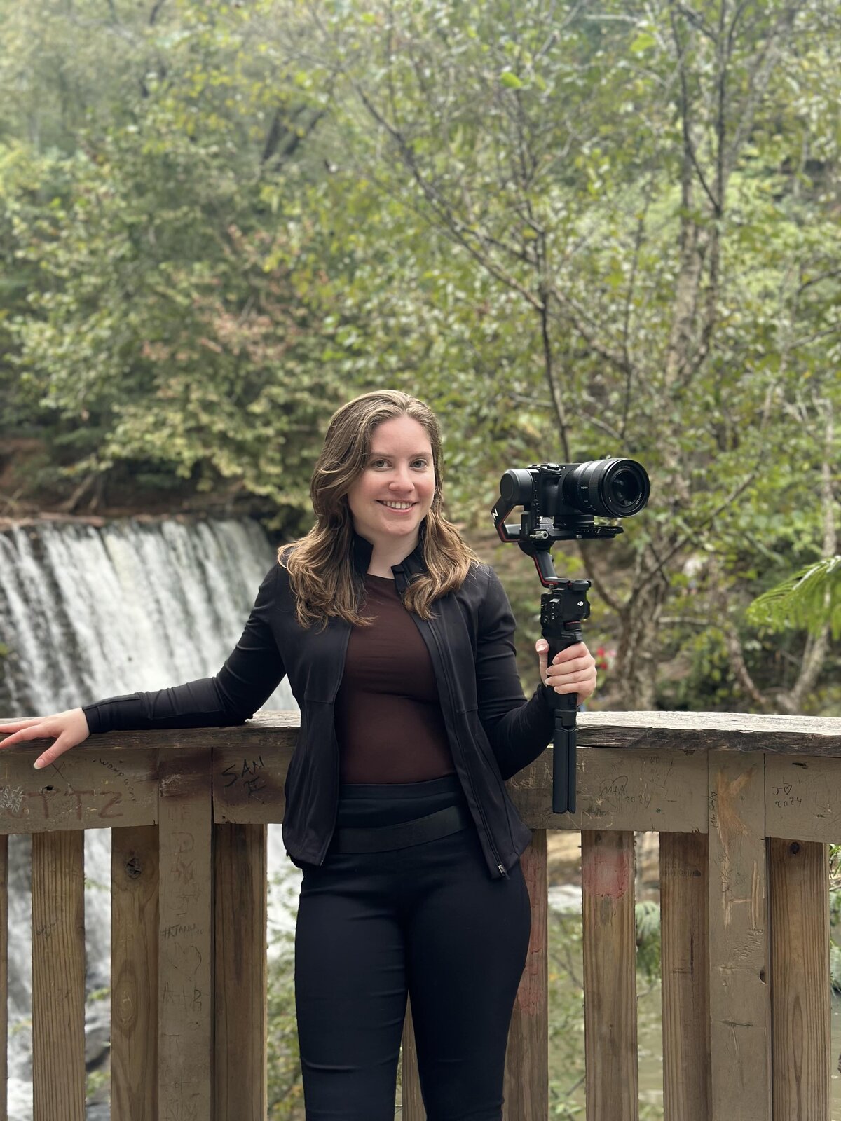 Proposal videographer waiting for couple at Roswell Mill Waterfall.