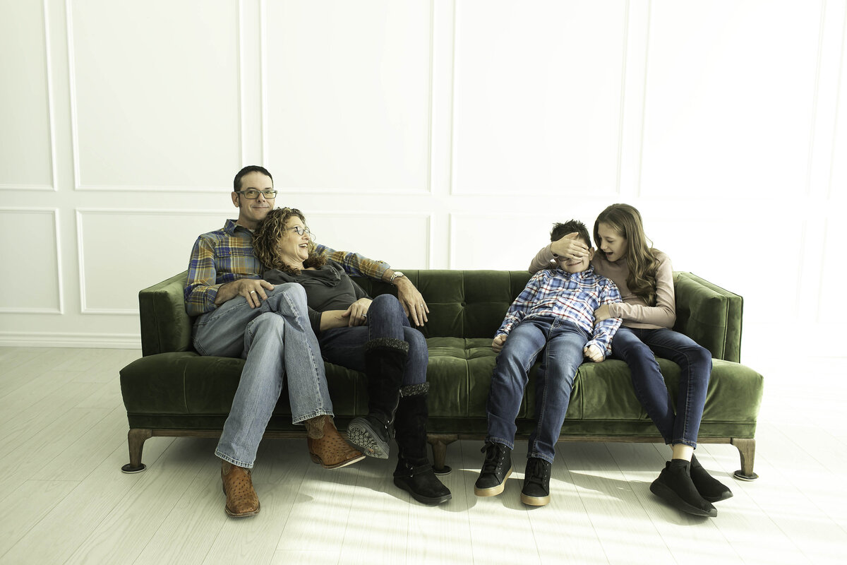 Parents and kids sharing a lighthearted, fun-filled moment as they strike playful poses for their family photoshoot