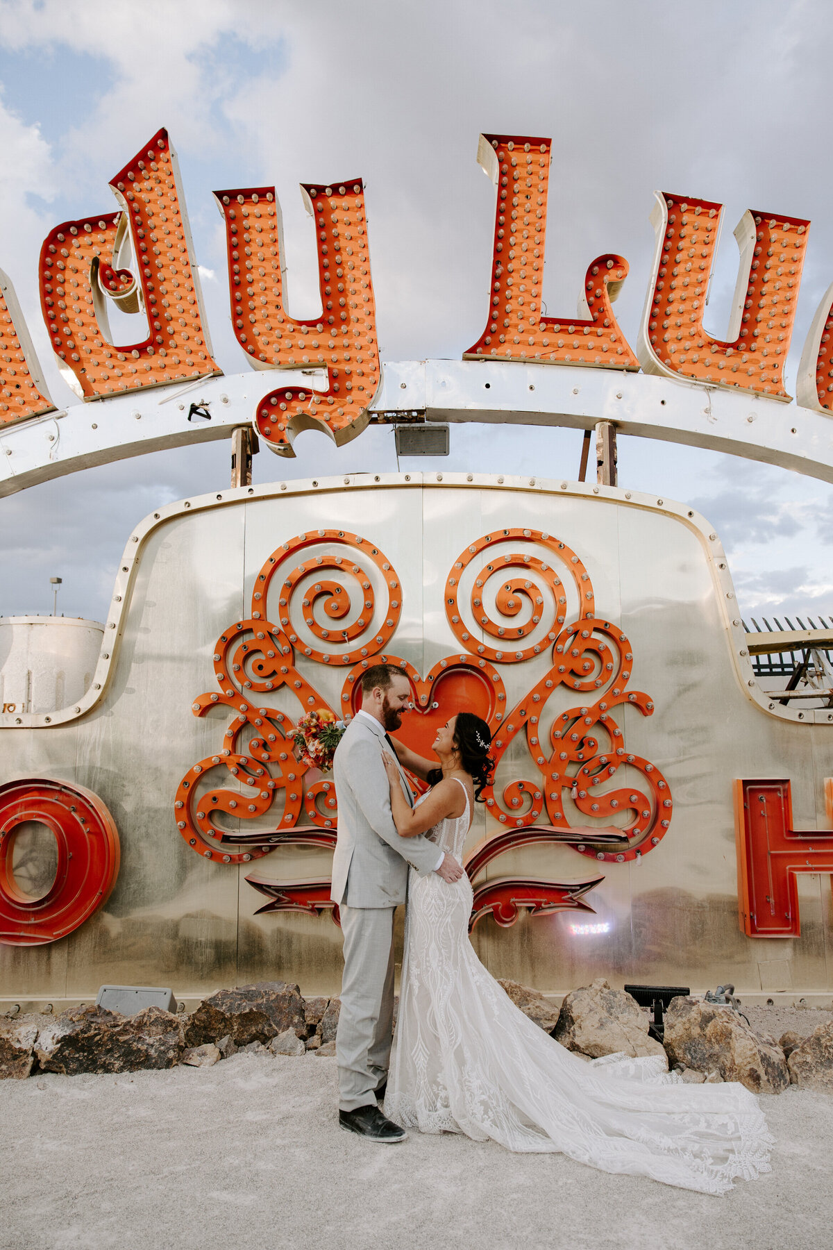 Two people look into each other's eyes during their Neon Museum wedding.