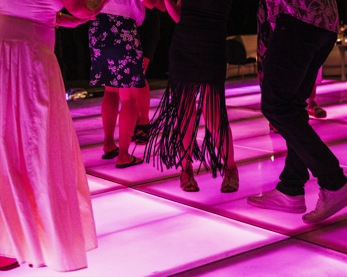Photo of neon pink dance floor and black fringe dress in private backyard party by Mira Park Photography NY based wedding photographer