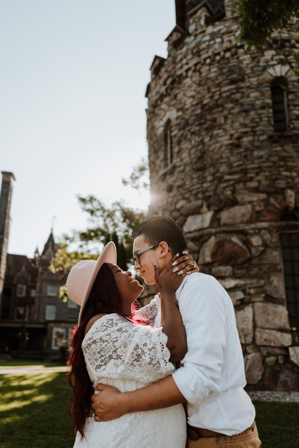 Married couple hugging at Boldt Castle in Thousand Islands, NY at sunset.