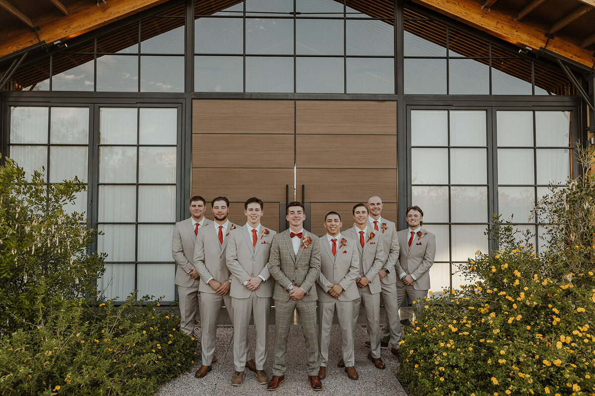 A groom and his groomsmen wearing groomsmen attire