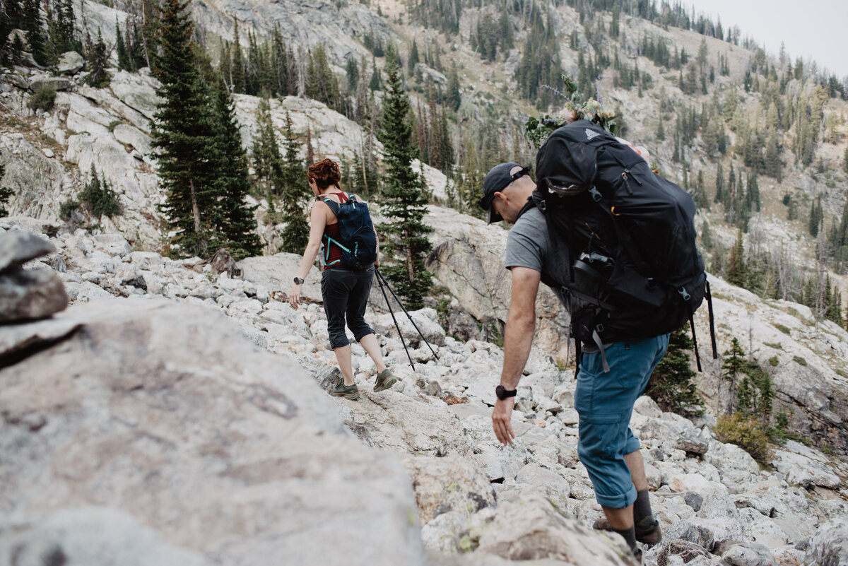 Jackson Hole photographers capture man and woman hiking over rocks