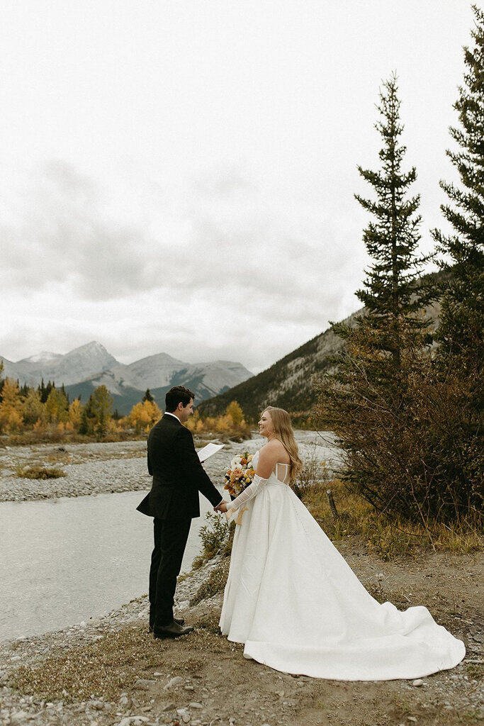 Bride and groom reading vows together in the mountains by Court Amber Photography, joyful and adventurous wedding photographer in Calgary, Alberta. Featured on the Bronte Bride Vendor Guide.