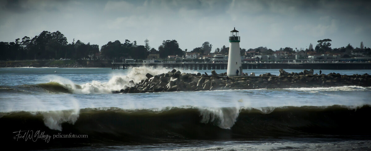 Breaking waves at Santa Cruz Harbor’s Walton Lighthouse, viewed from Twin Lakes Beach.