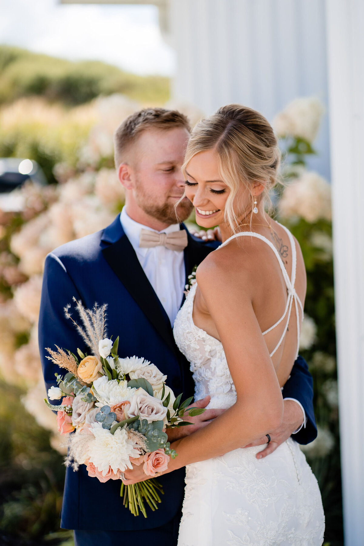 Bride and groom embracing on their wedding day in Rockford, IL. Bridal beauty services.