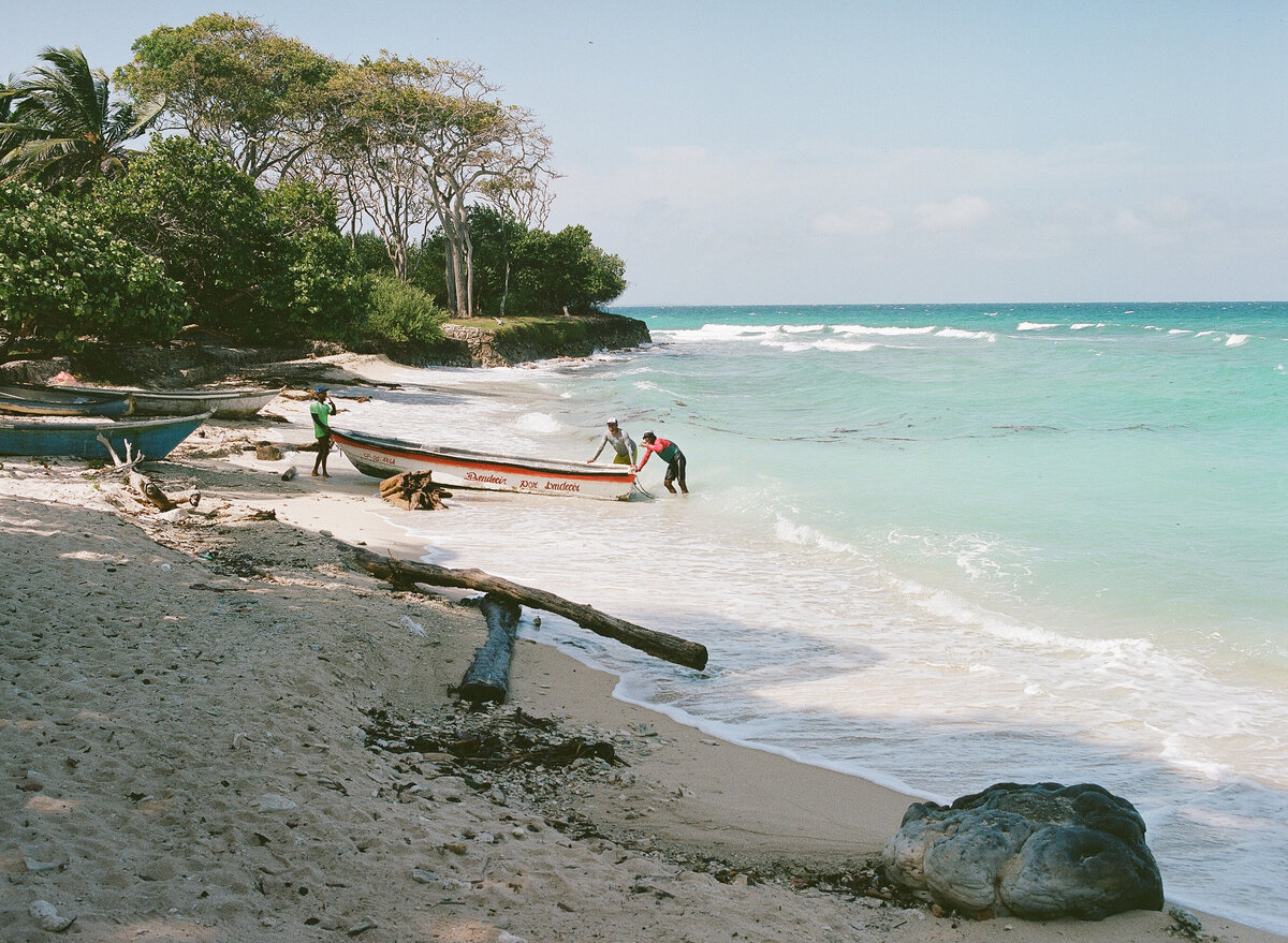 Fisherman with boat on the beach in Colombia