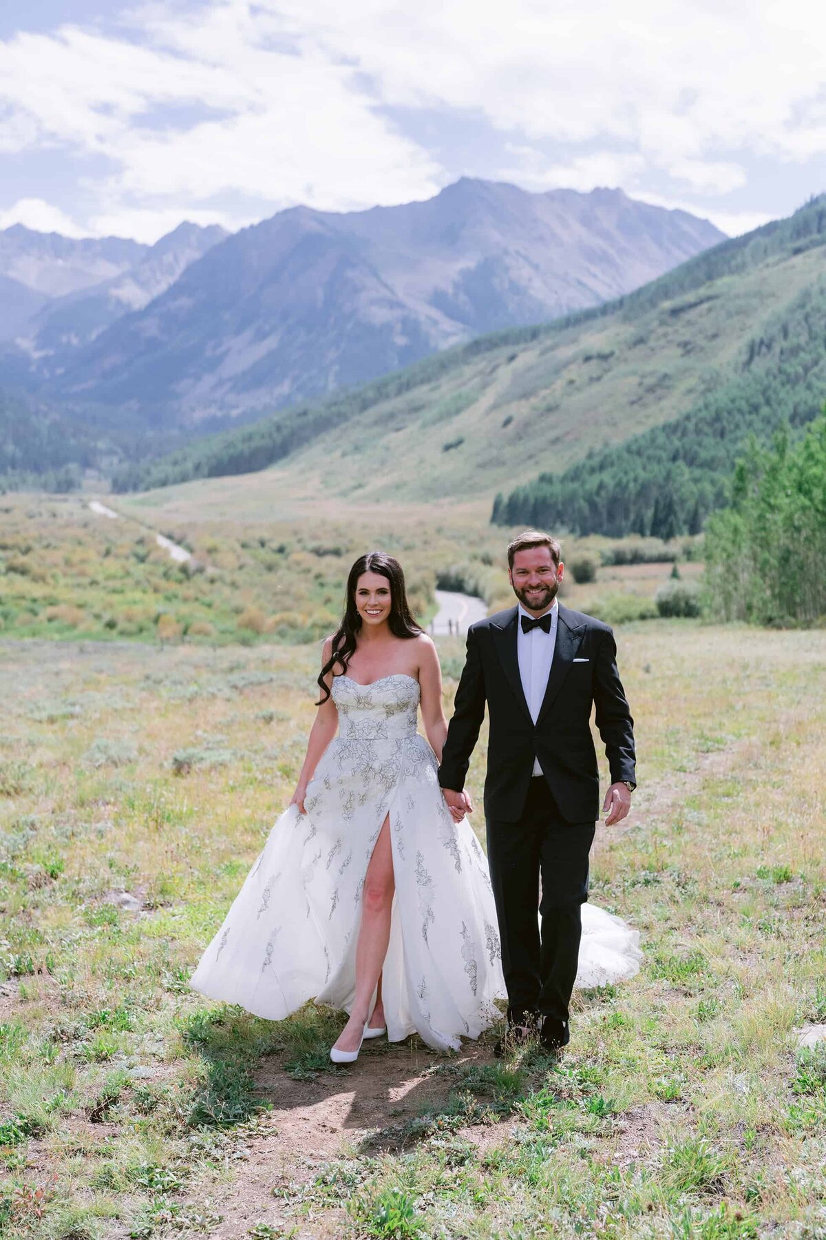 Smiling bride and groom in an outdoor mountain setting