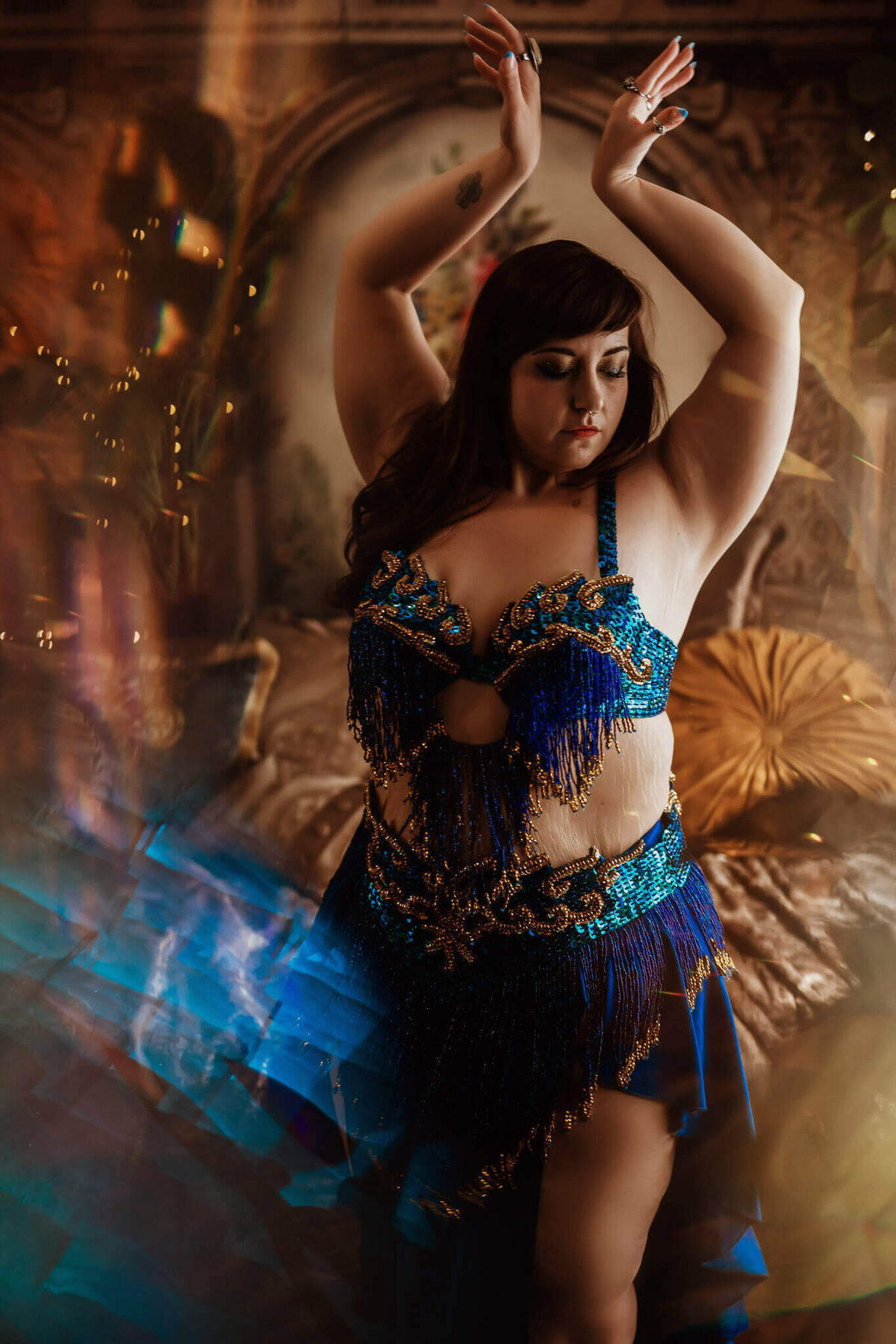 Woman in blue belly dancing costume in a Fort Worth boudoir studio