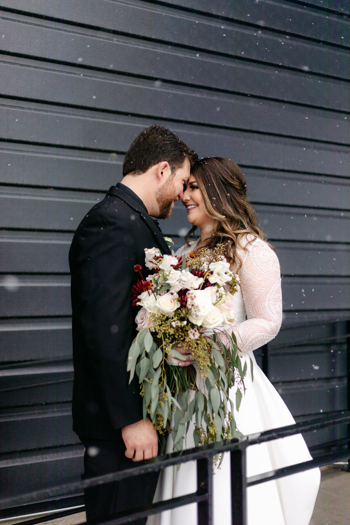 A bride and groom embrace during their wedding at the Windsor Mill in Windsor, Colorado.