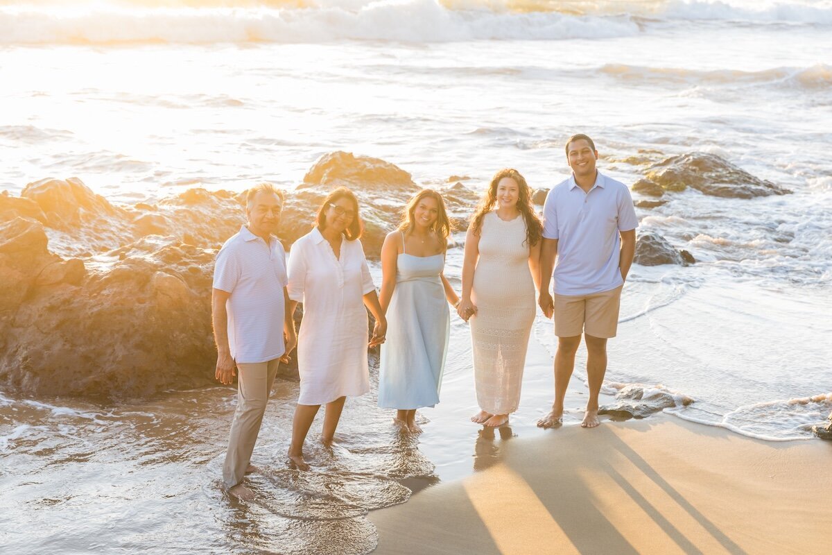 Adult family portraits in Maui with beautiful golden sunlight coming from behind the photo.