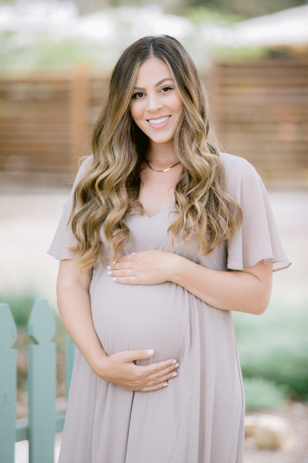 A mother holding her pregnant stomach