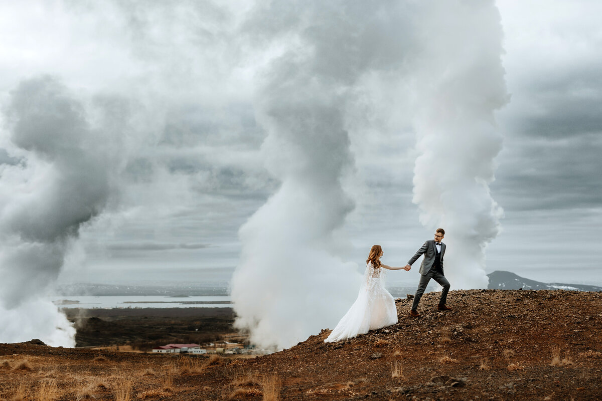 married couple is exploring a geothermal area in north Iceland