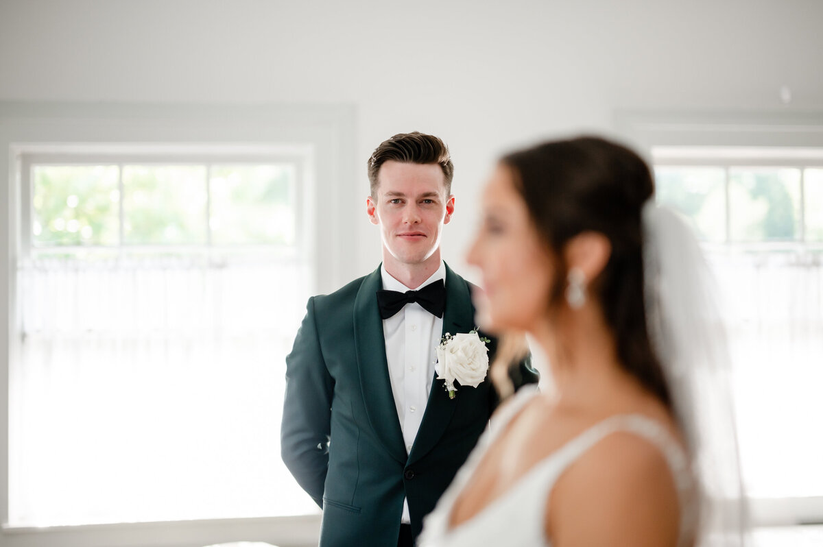 A groom looks at his bride at Cheney Mansion in Oak Park, Illinois