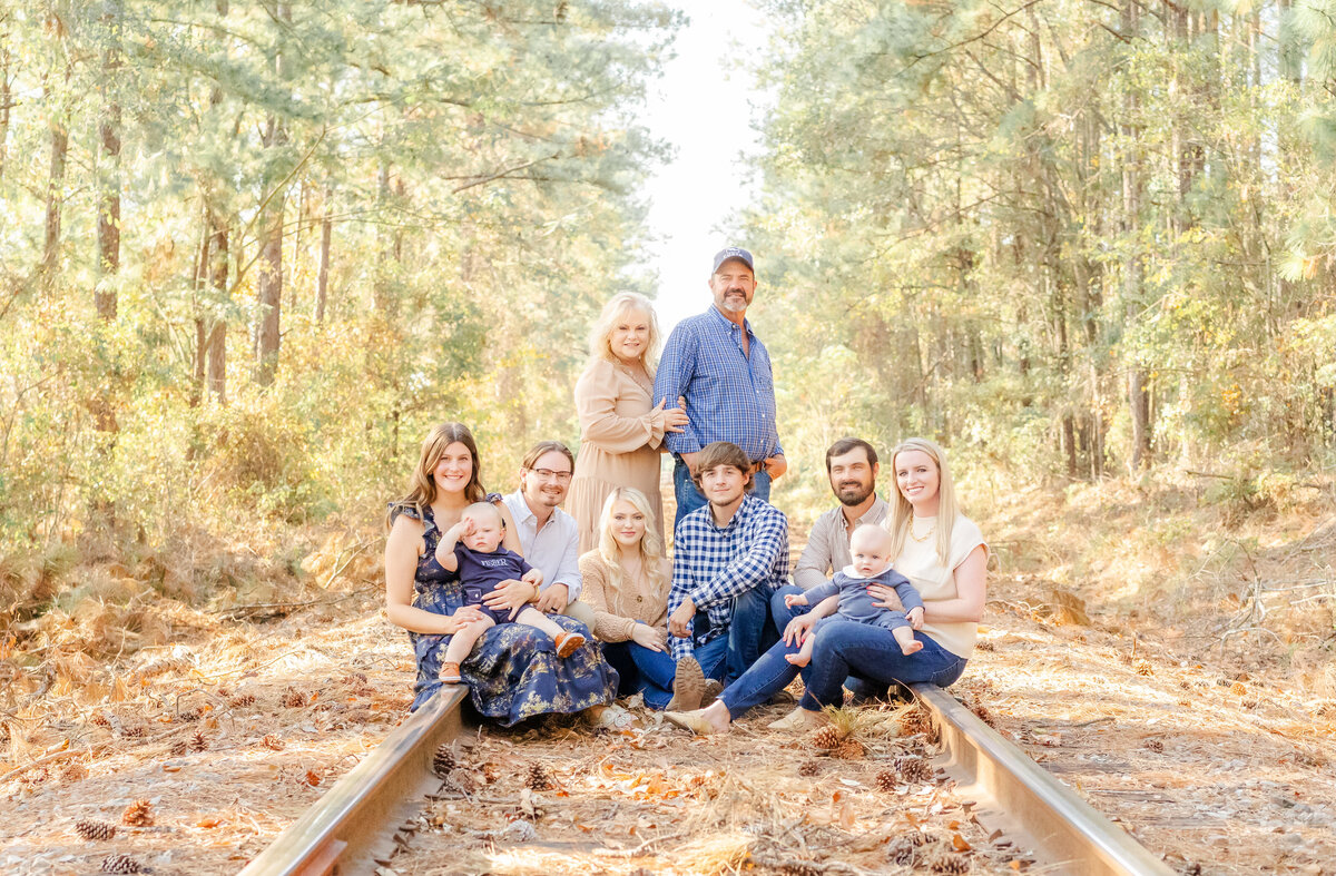 parents, children with spouses and children on railroad tracks 