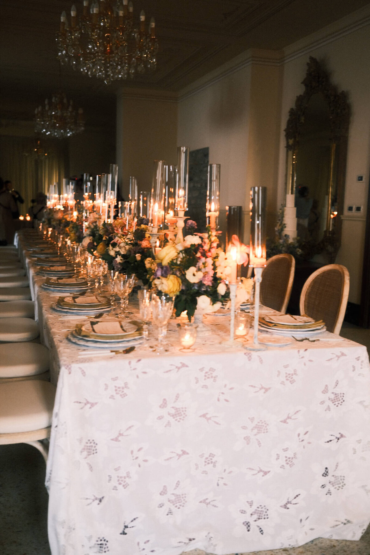 A wedding day photo of the reception cable covered in linens and candles at the wedding venue Villa Aura del Lago on Lake Como in Italy