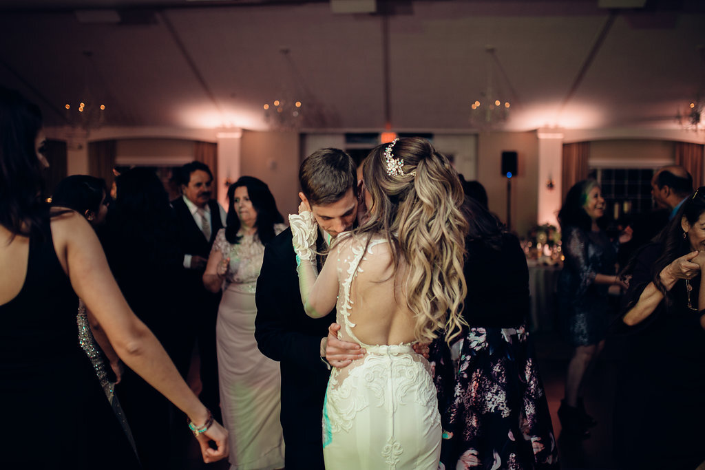 Wedding Photograph Of Bride And Groom Hugging Each Other While Dancing In The Middle Of The Crowd Los Angeles