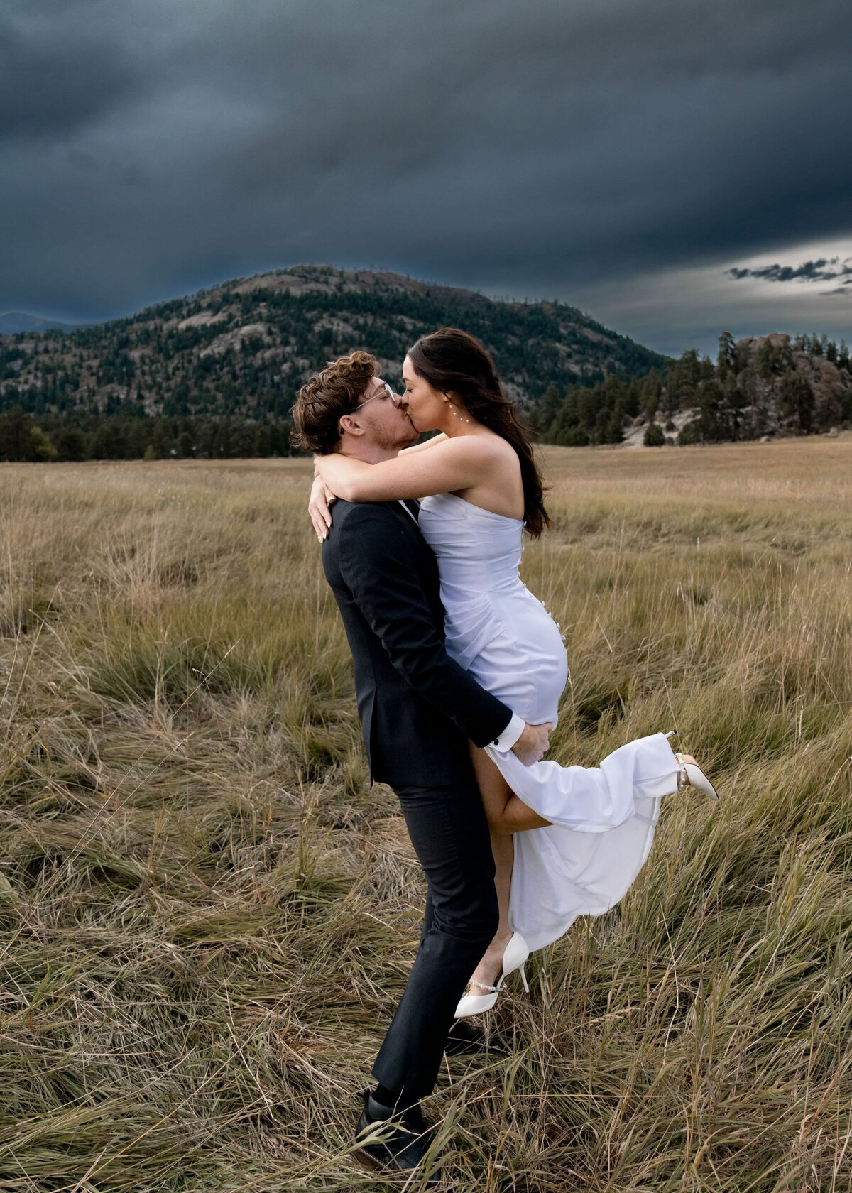 denver colorado wedding photographer - groom lifting bride in air