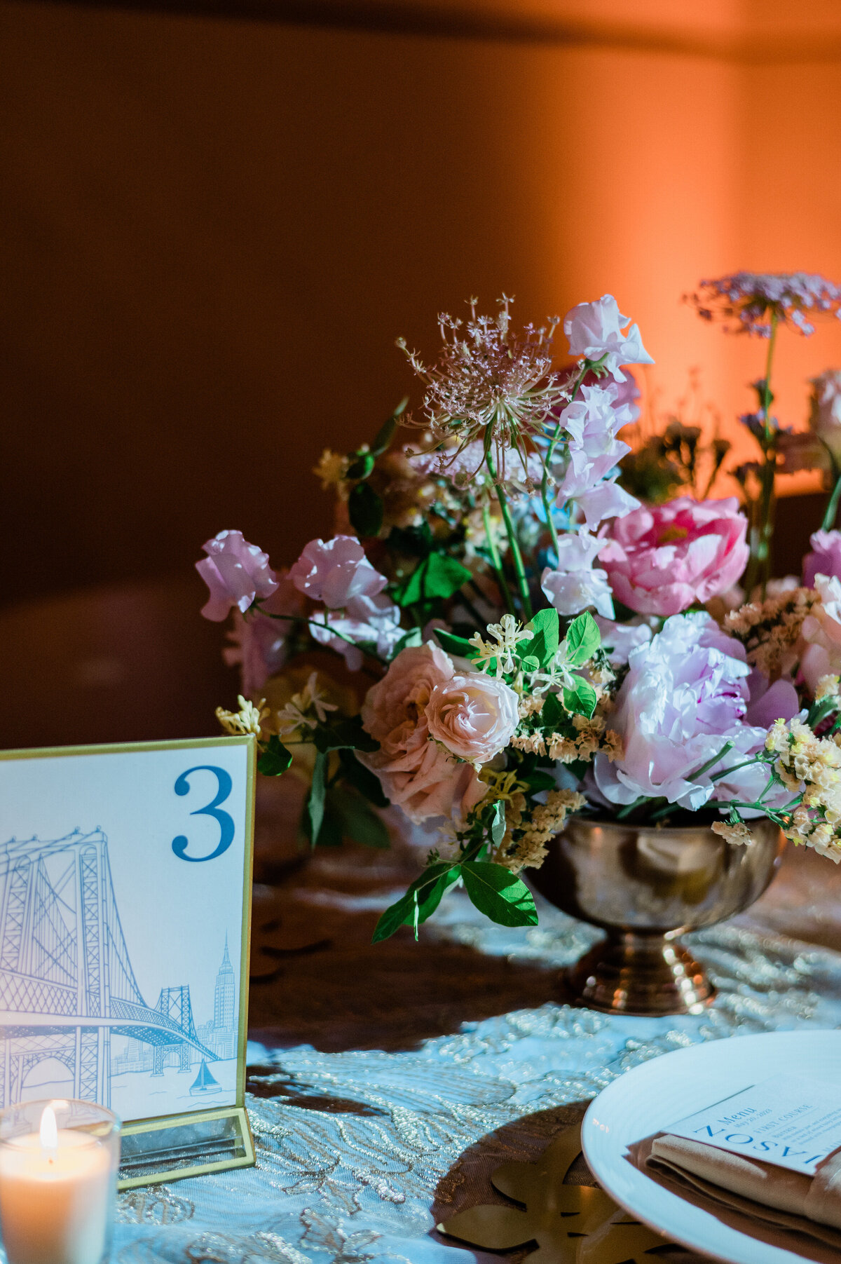 Table number and floral arrangement sit on reception table 