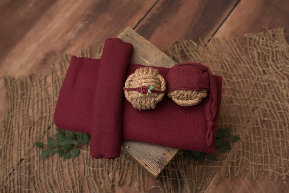 red wrap, headband and hat on brown crate